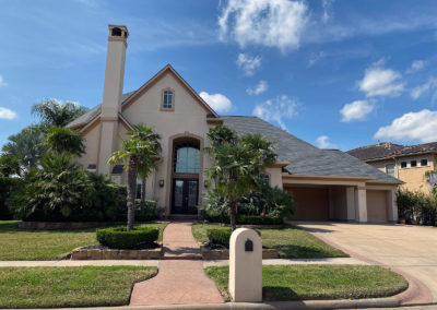 A house with a driveway and a lot of grass